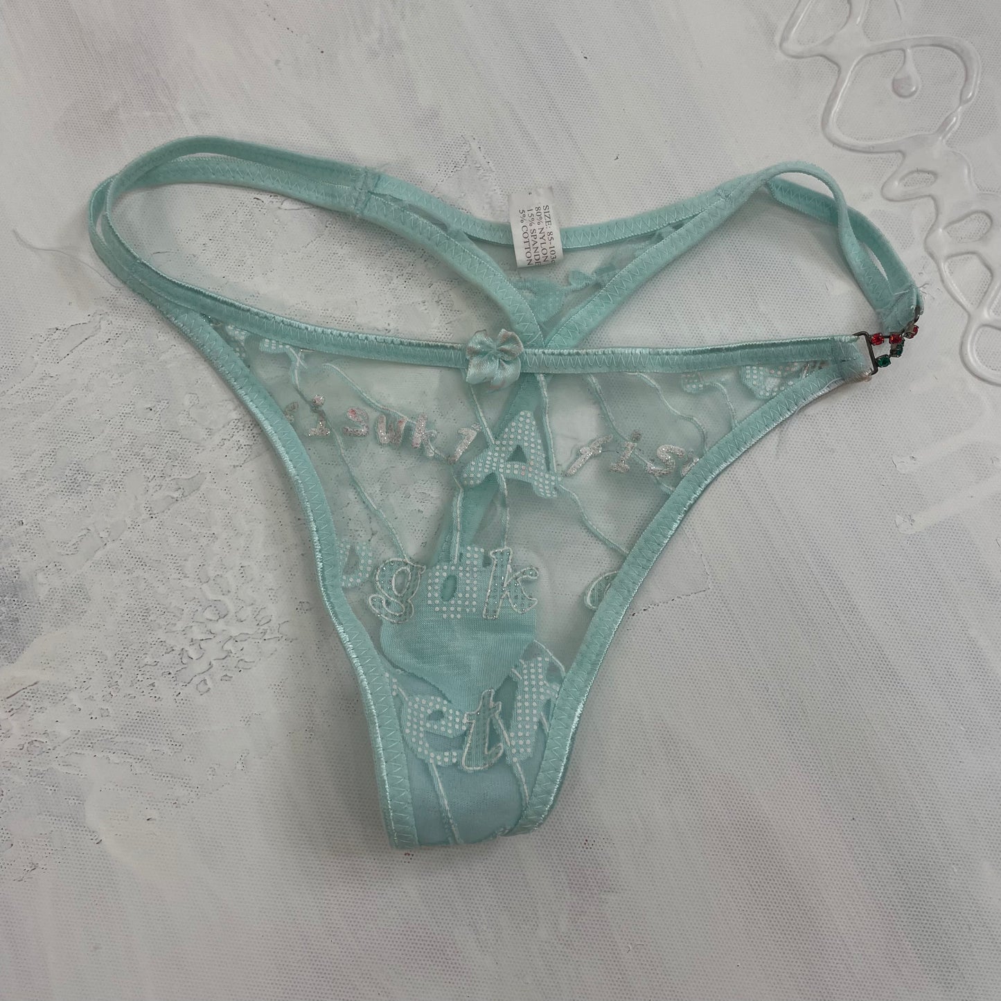 💻POSH AND BECKS DROP | small blue mesh thong with letter print