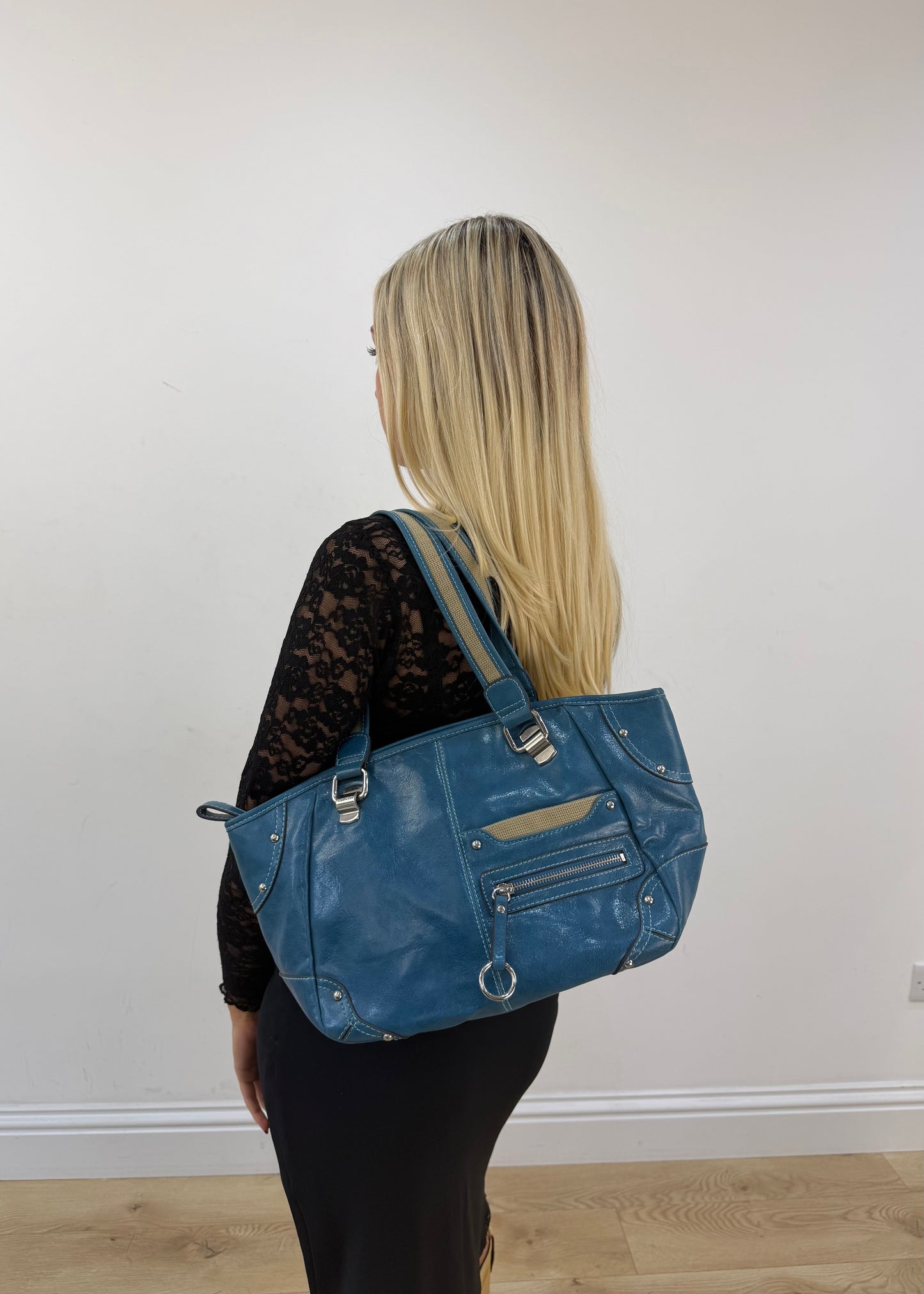 blue shoulder tote bag with silver hardware detail view