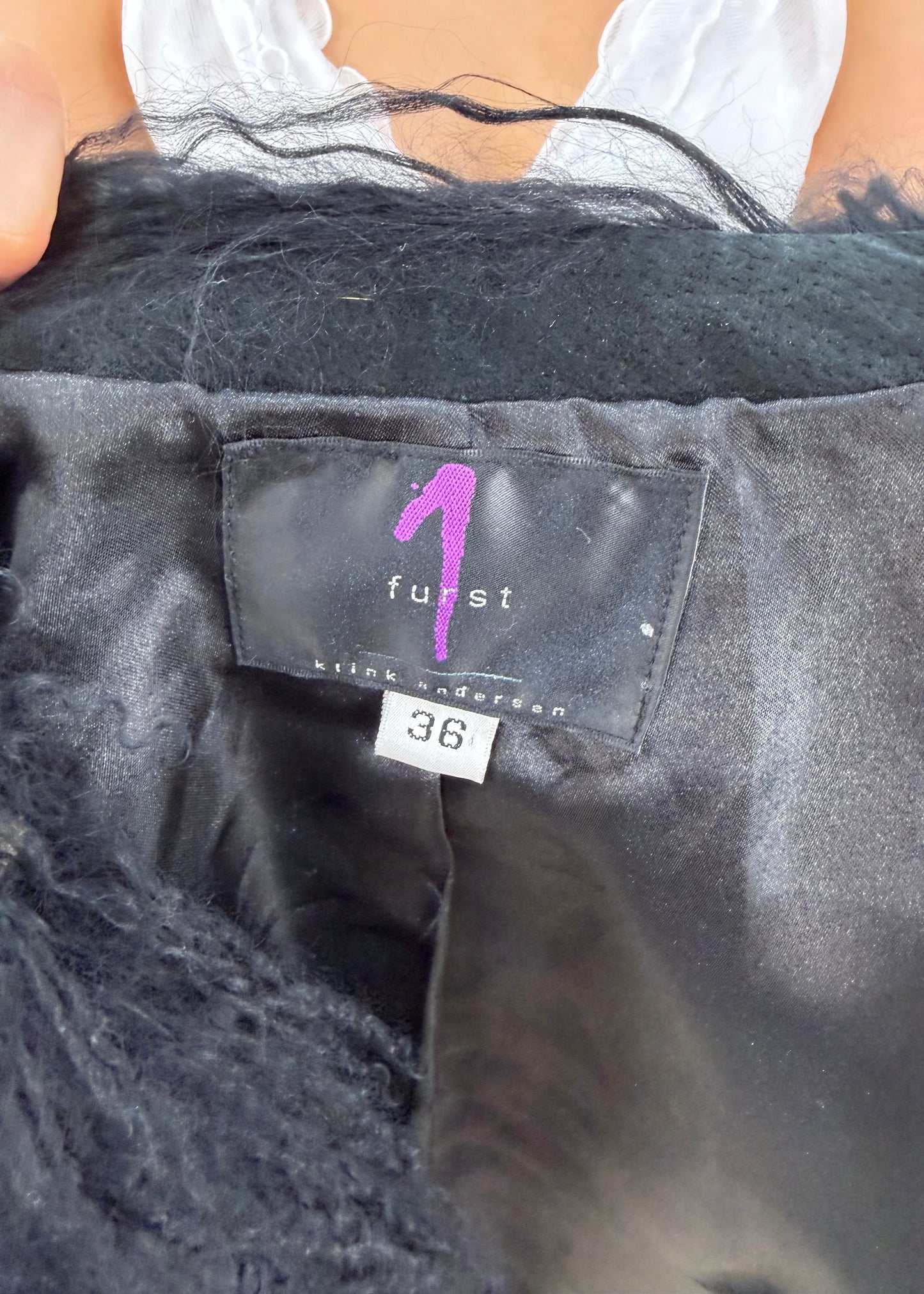 small black faux fur gilet label