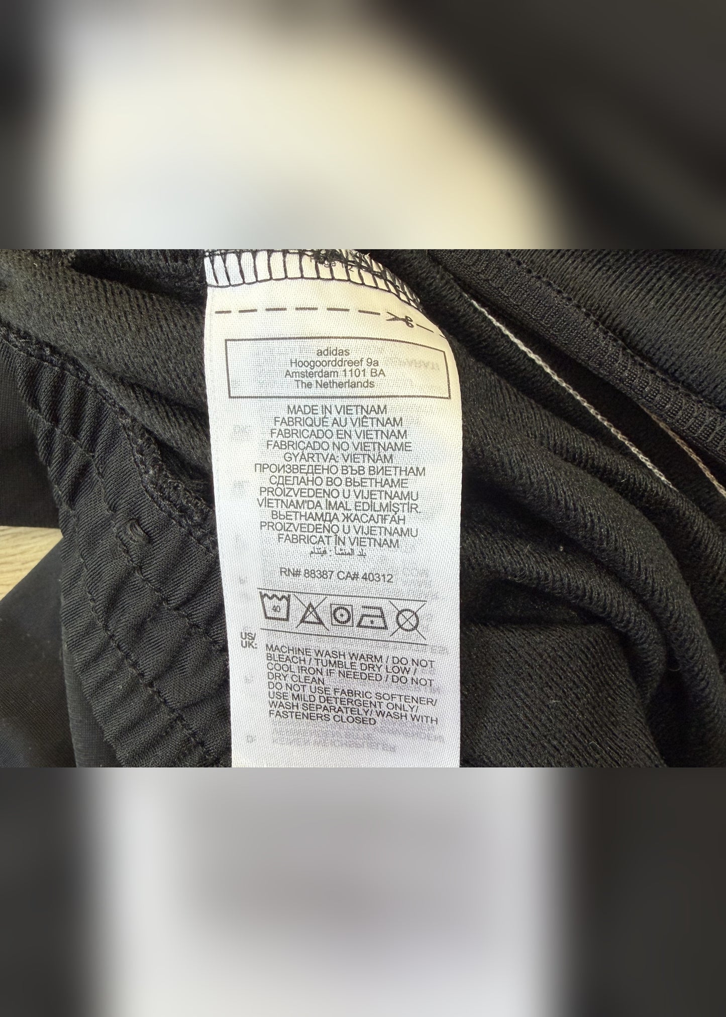 small black adidas tracksuit bottoms label