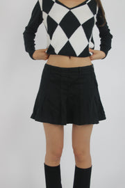 black pleated mini skirt front view