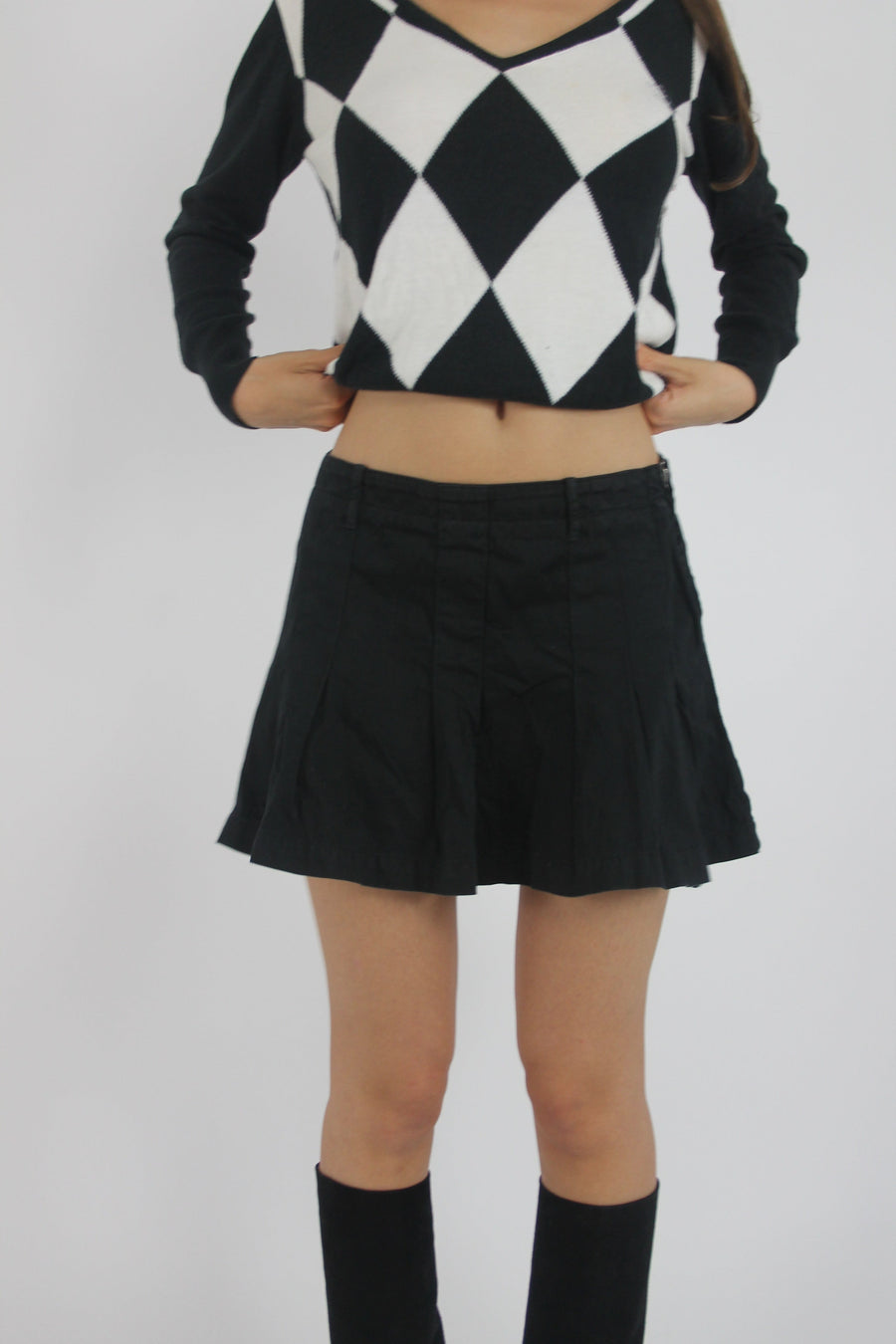 black pleated mini skirt front view