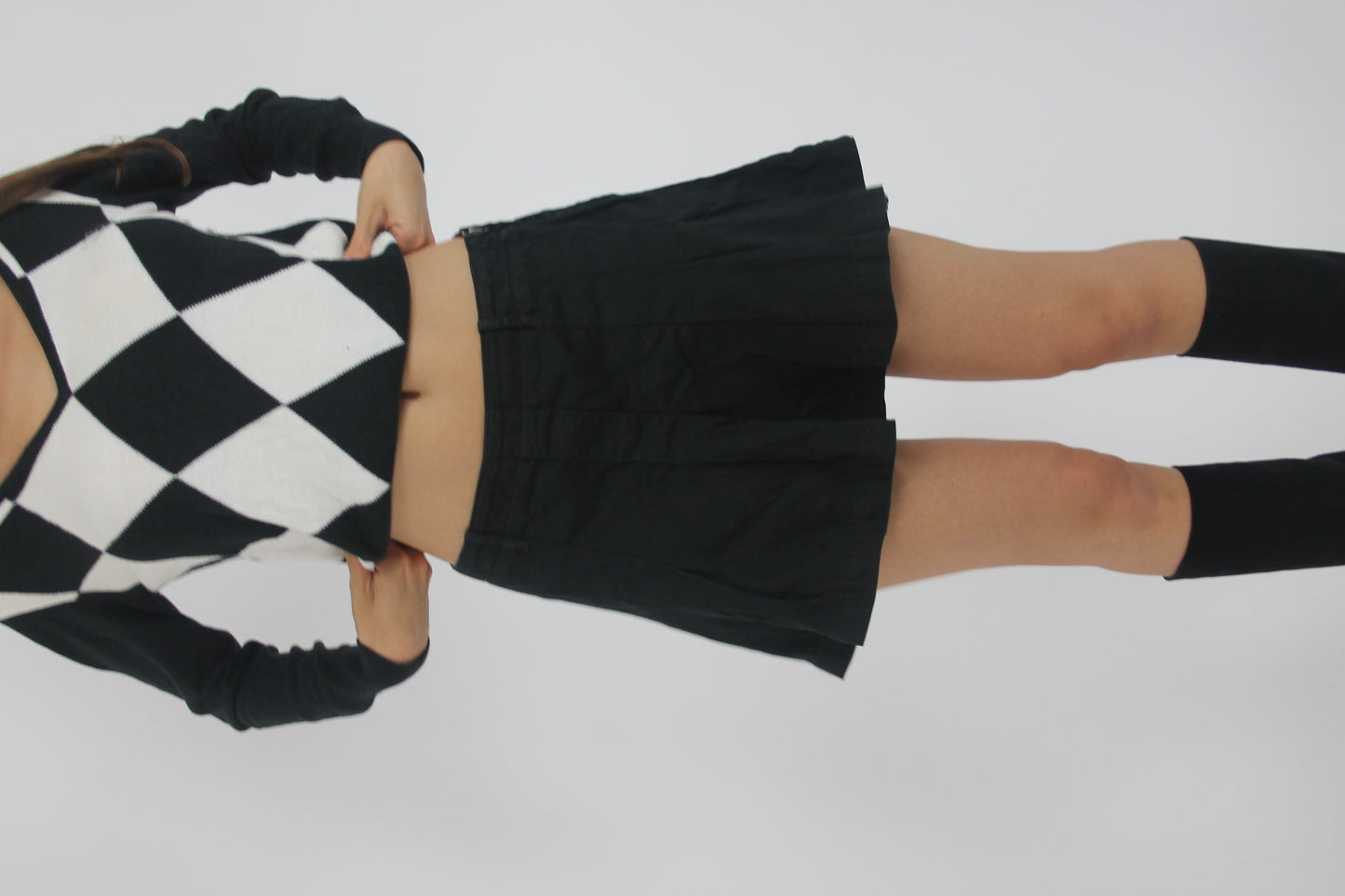 black pleated mini skirt front view