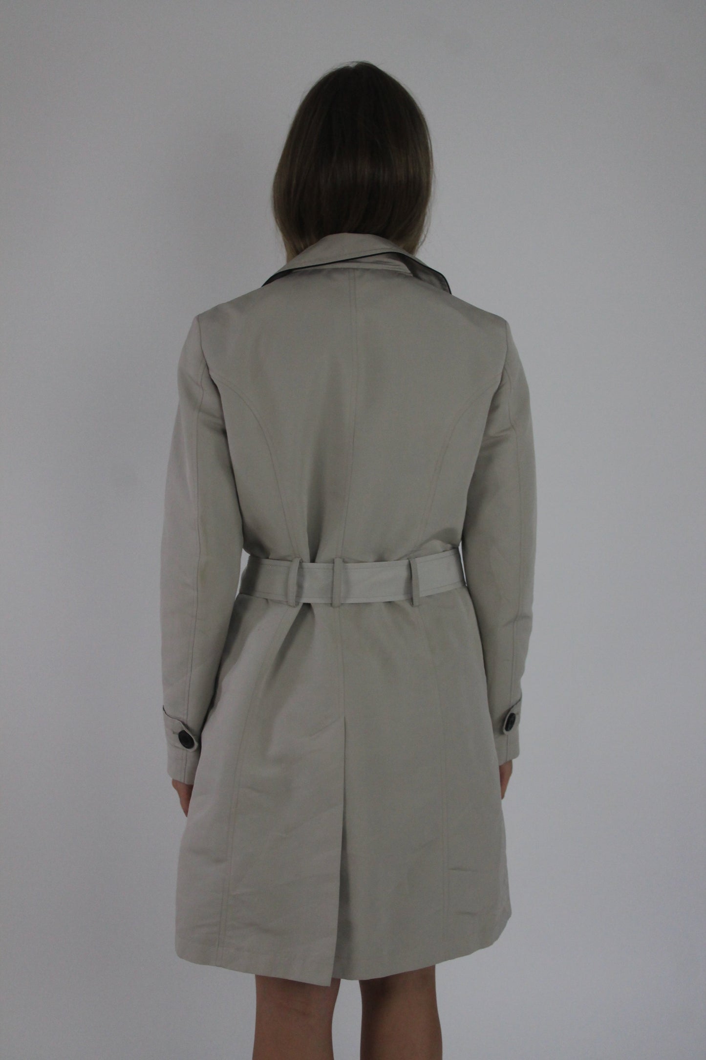 beige belted trench coat back view