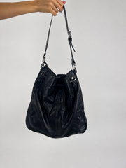 black hobo handbag with hanging details back view