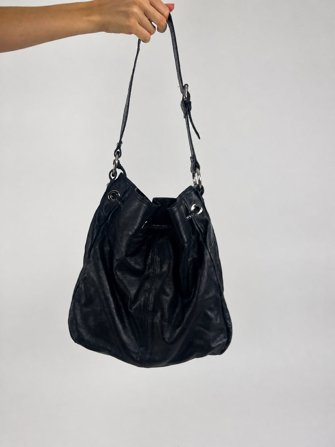 black hobo handbag with hanging details back view