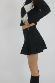 black pleated mini skirt back view