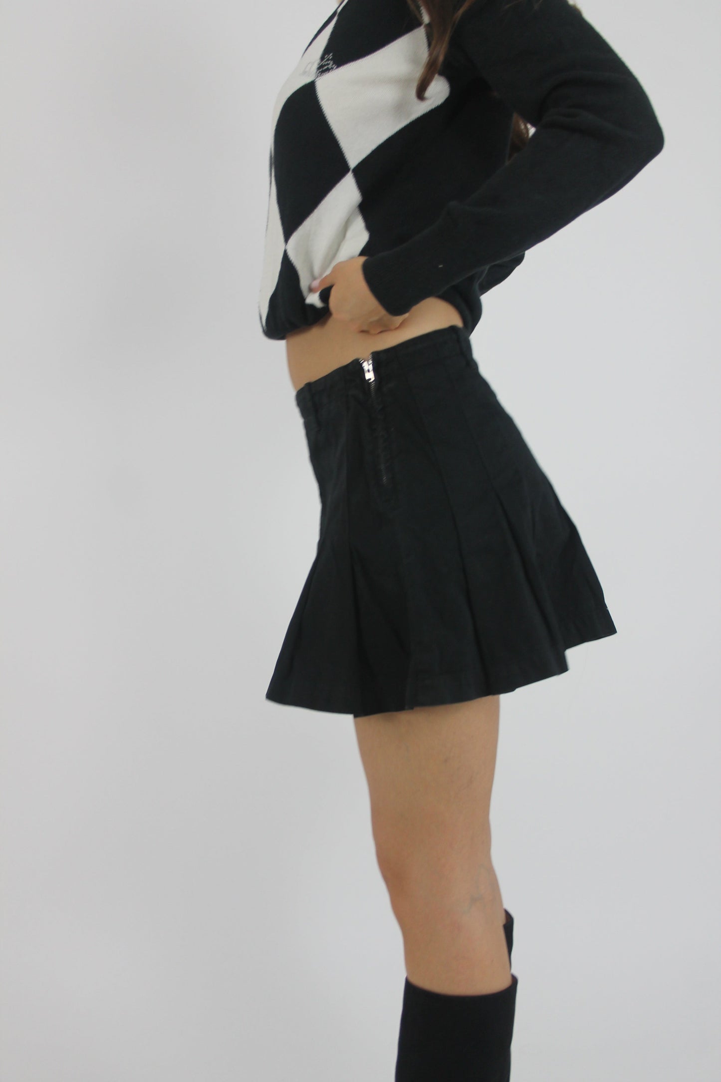 black pleated mini skirt back view
