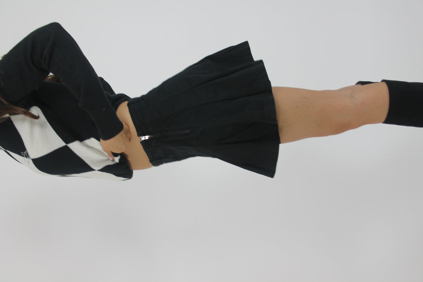 black pleated mini skirt back view