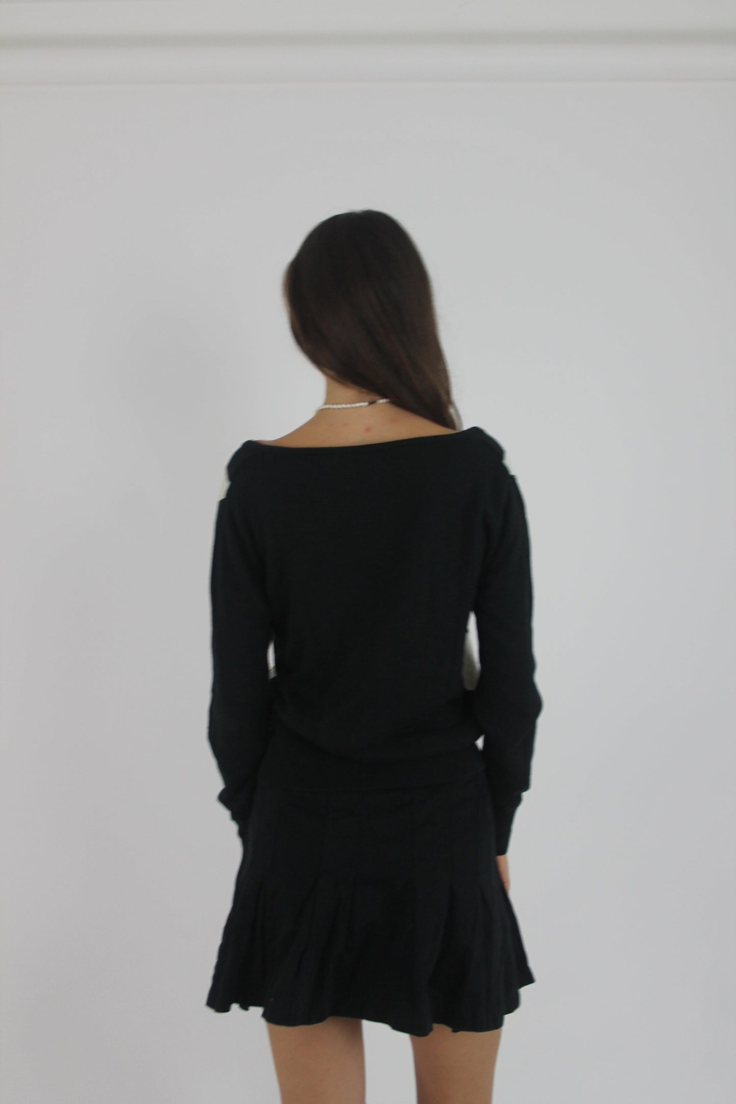 black and white argyle v-neck jumper back view