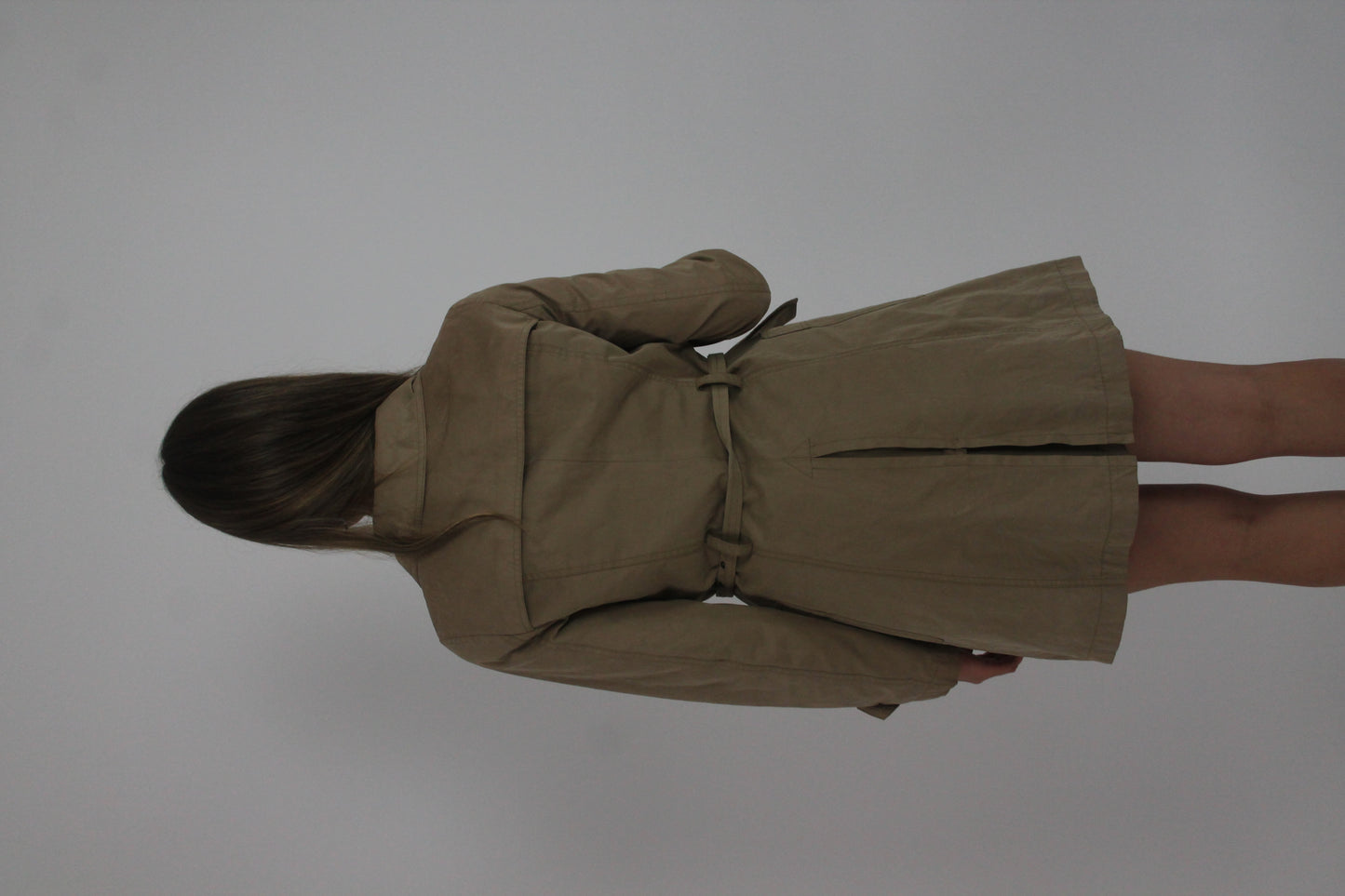 tan belted trench coat back view