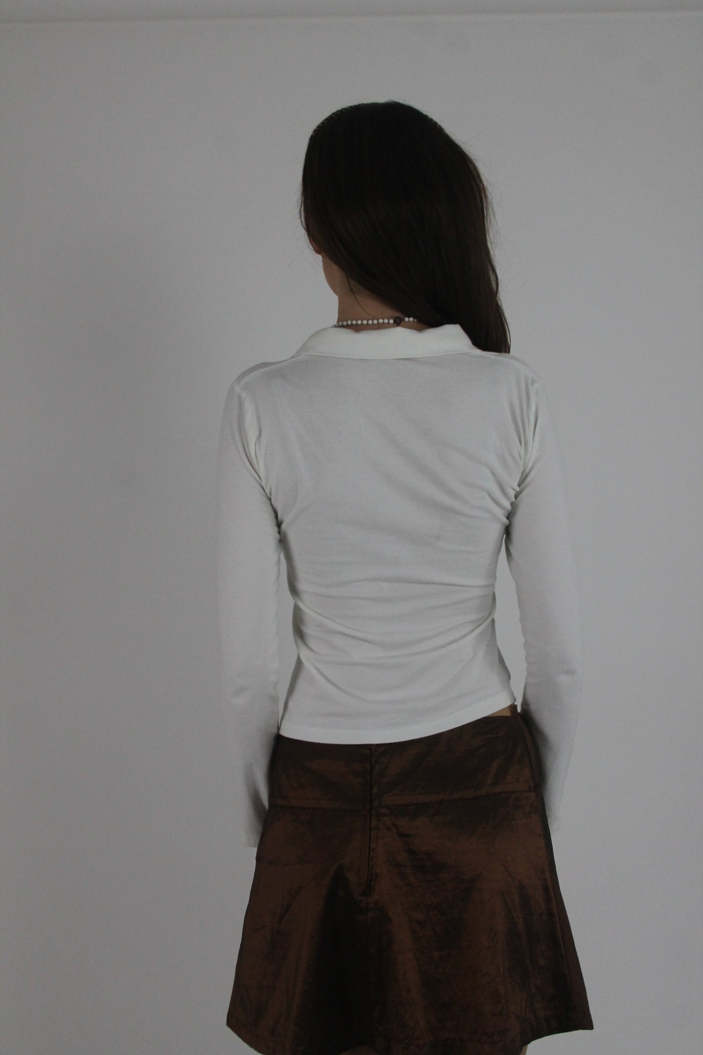 white collared v-neck long-sleeve top back view
