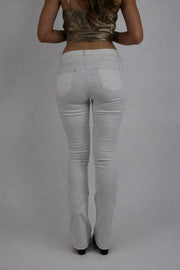 white low-rise flared jeans back view