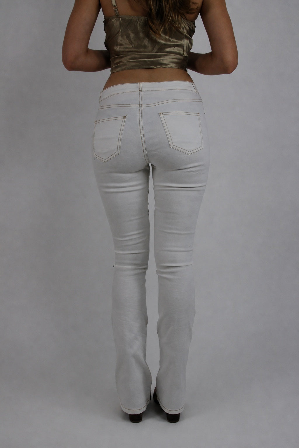 white low-rise flared jeans back view