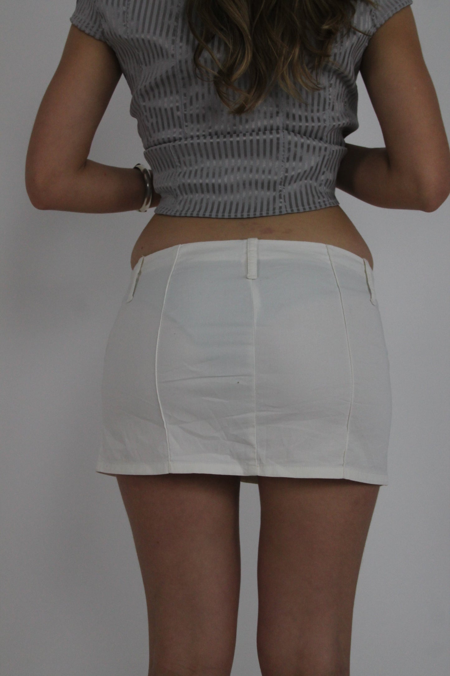 white mini skirt with front pockets back view