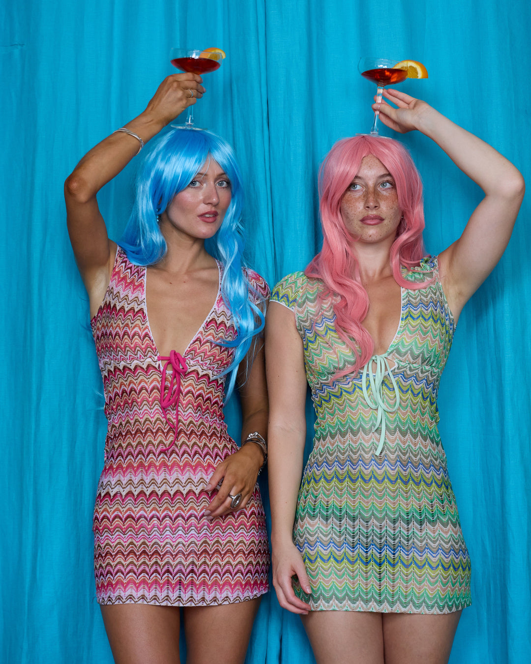 Models wearing Allegra Dresses in Candyfloss Pink and Pistachio Green