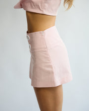 Model wearing the Penelope Pea Skirt in Powder Pink – side view