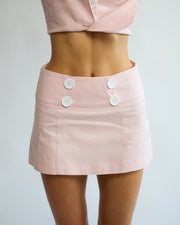 Model wearing the Penelope Pea Skirt in Powder Pink – front view