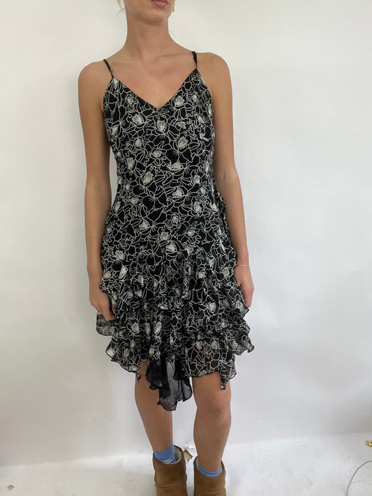 COACHELLA DROP | small black and white ruffle midi dress with floral pattern all over