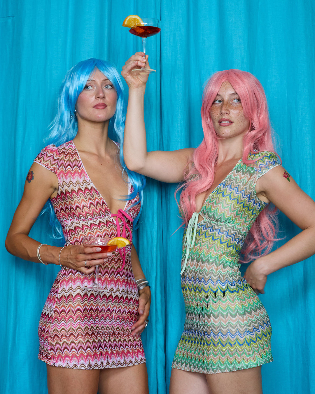 Models wearing Allegra Dresses in Candyfloss Pink and Pistachio Green