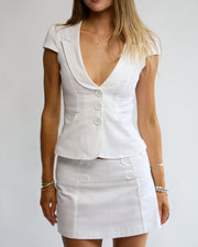 Model wearing the Penelope Pea Top and Skirt in White – front view