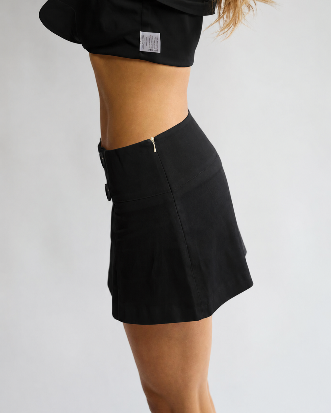 Model wearing the Penelope Pea Skirt in Black – side view