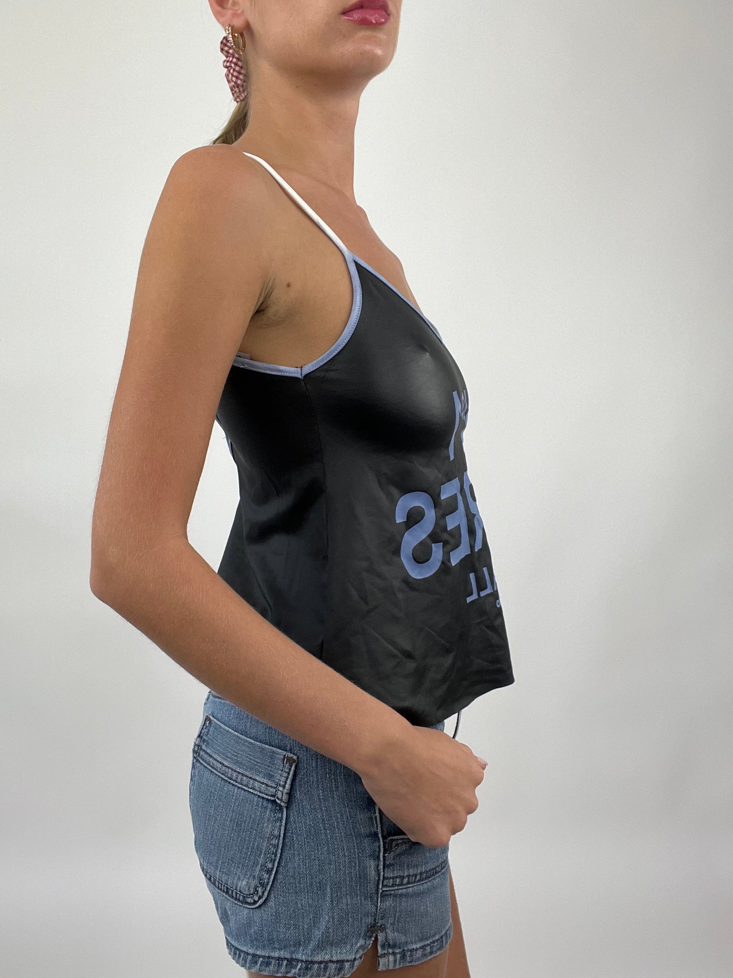 COASTAL COWGIRL DROP | small black cami with purple ‘no1 cares’ at all spell out