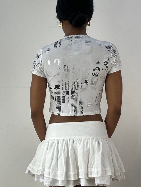 💻‼️ white and silver crop top with graphic newspaper print