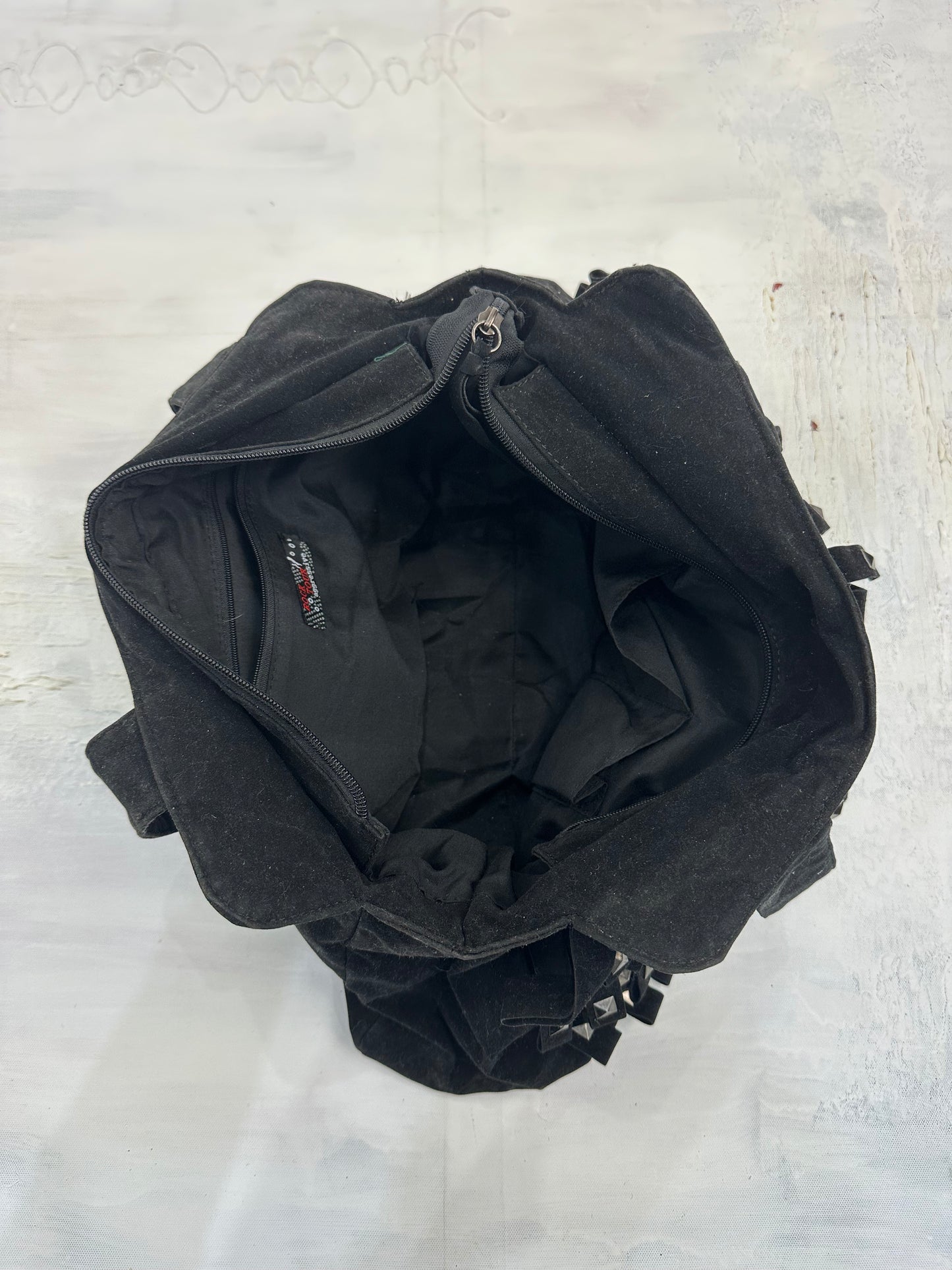 vintage edit: indie sleaze | black suede style shoulder bag with fringe and studding