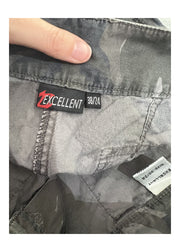 medium green and grey camo print trousers label