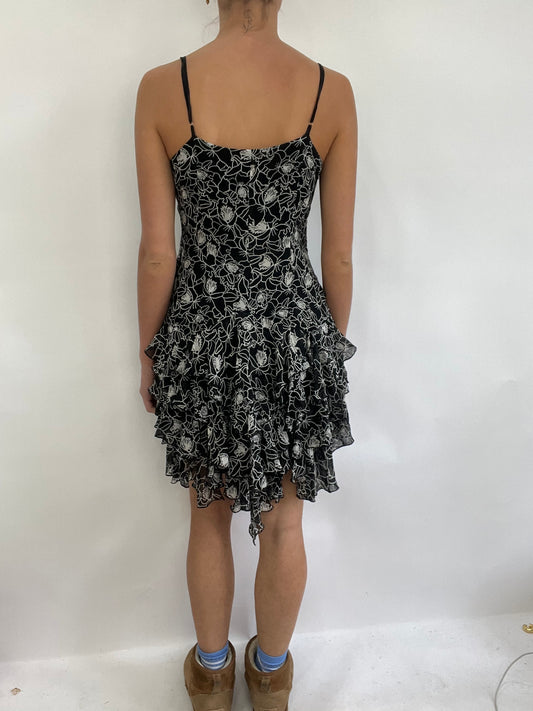 COACHELLA DROP | small black and white ruffle midi dress with floral pattern all over