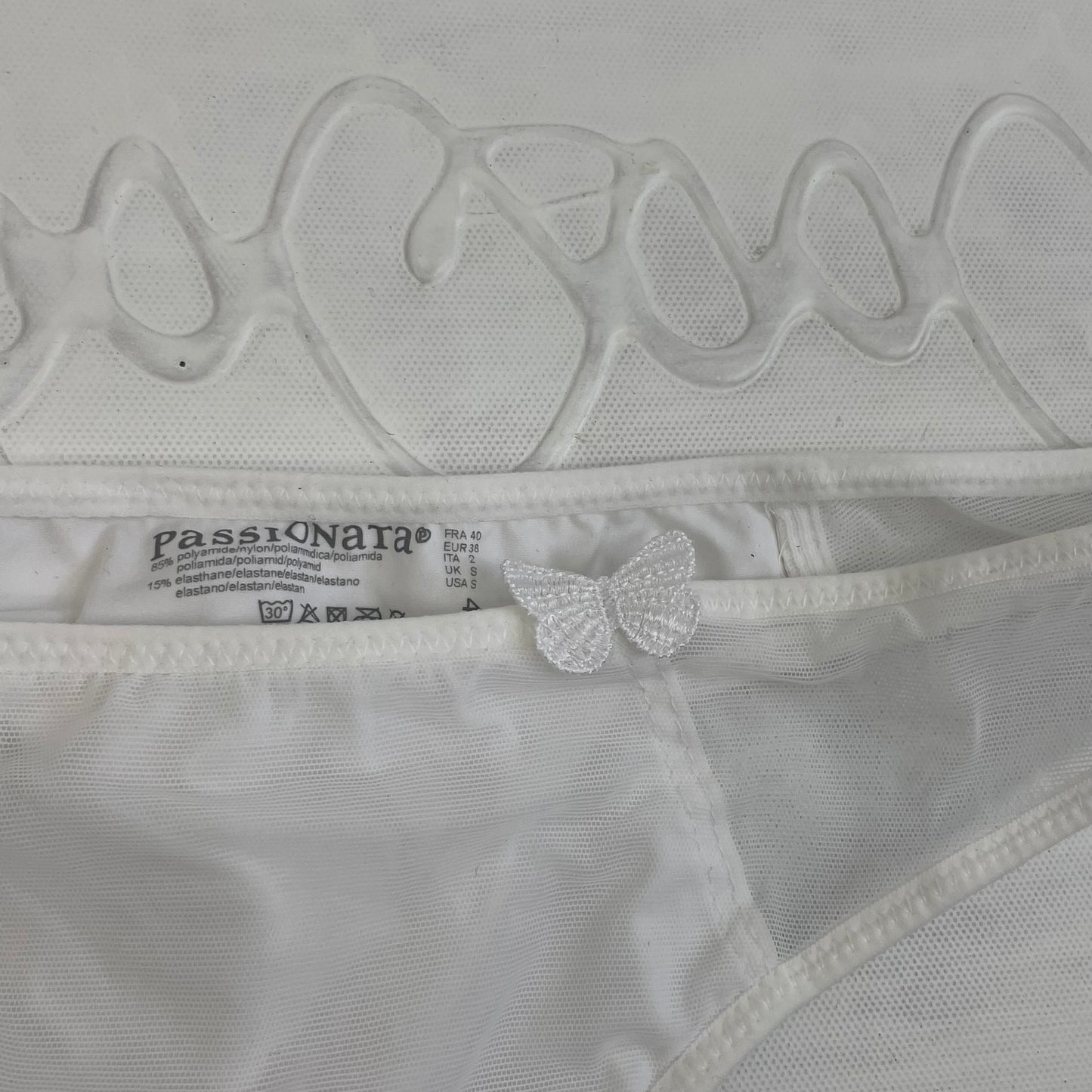 CHALET GIRL DROP | small white thong with butterfly detail – remass