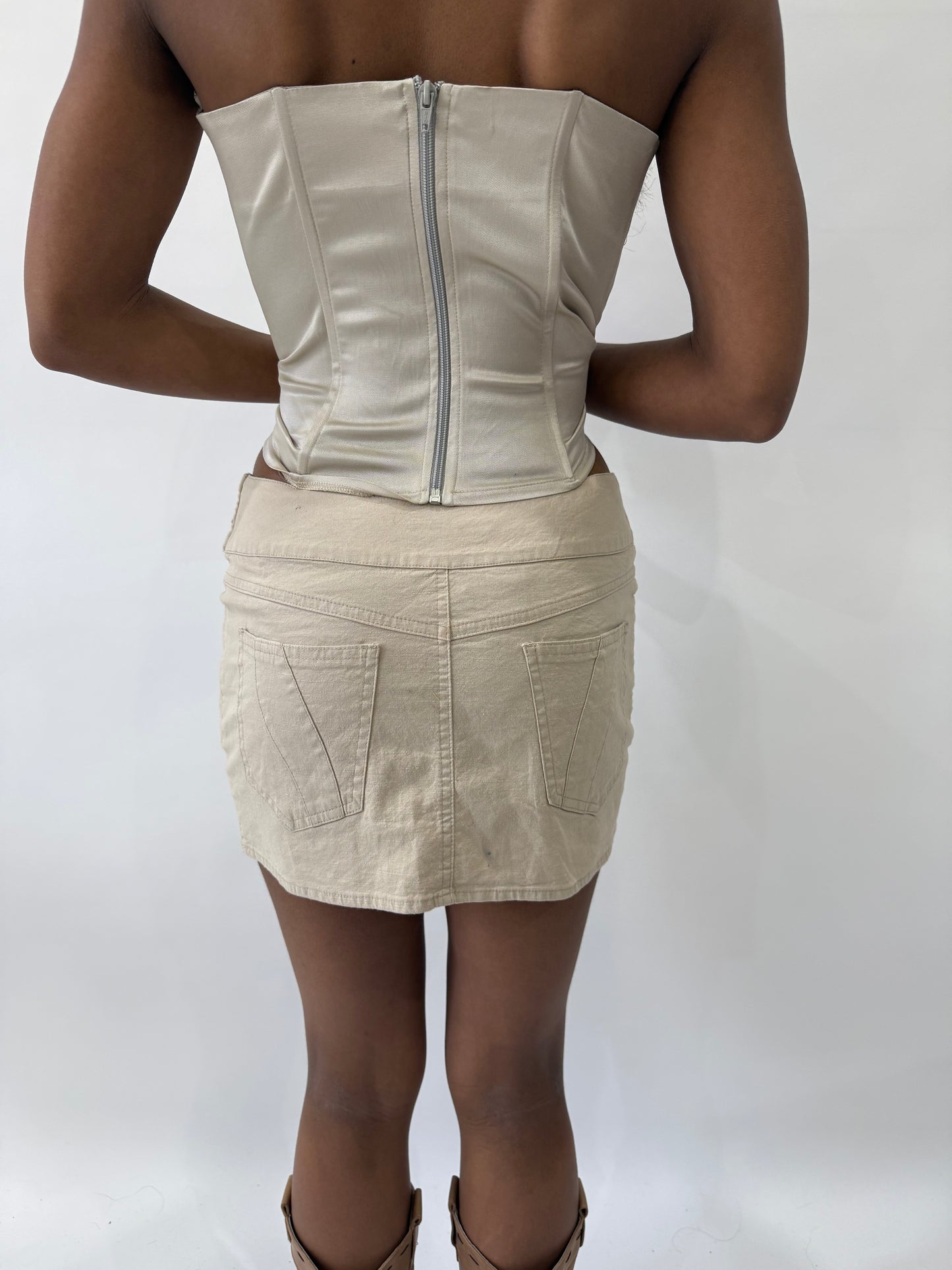 western edit | small beige jane norman buckle mini skirt