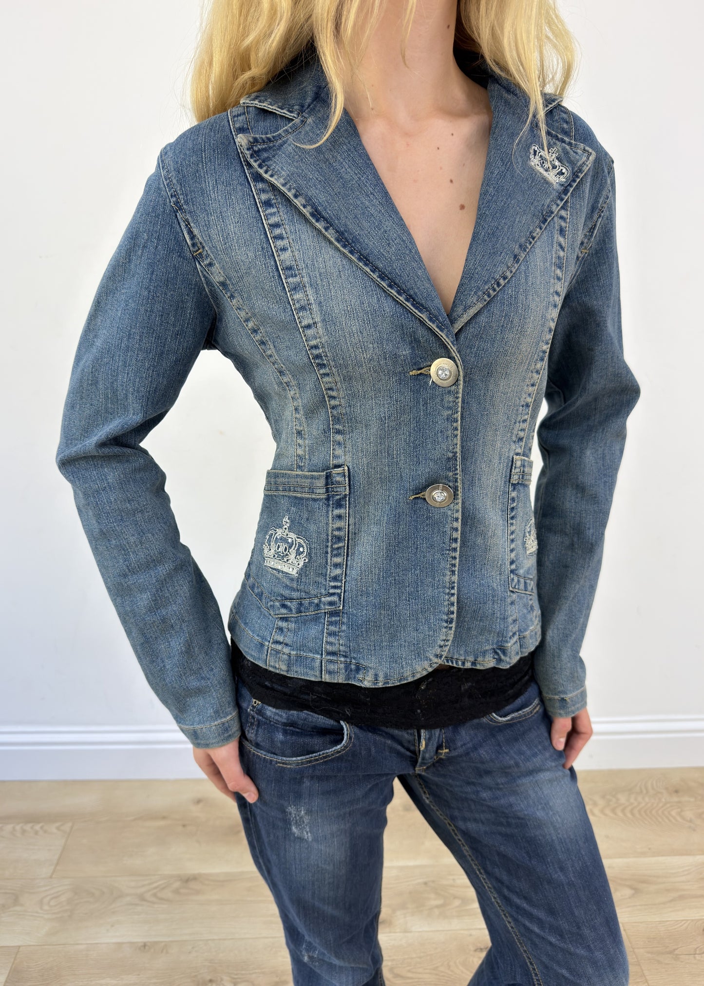 small denim blazer with embroidered crowns - face close-up