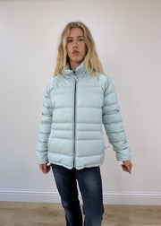 small pale blue puffer jacket - face close-up