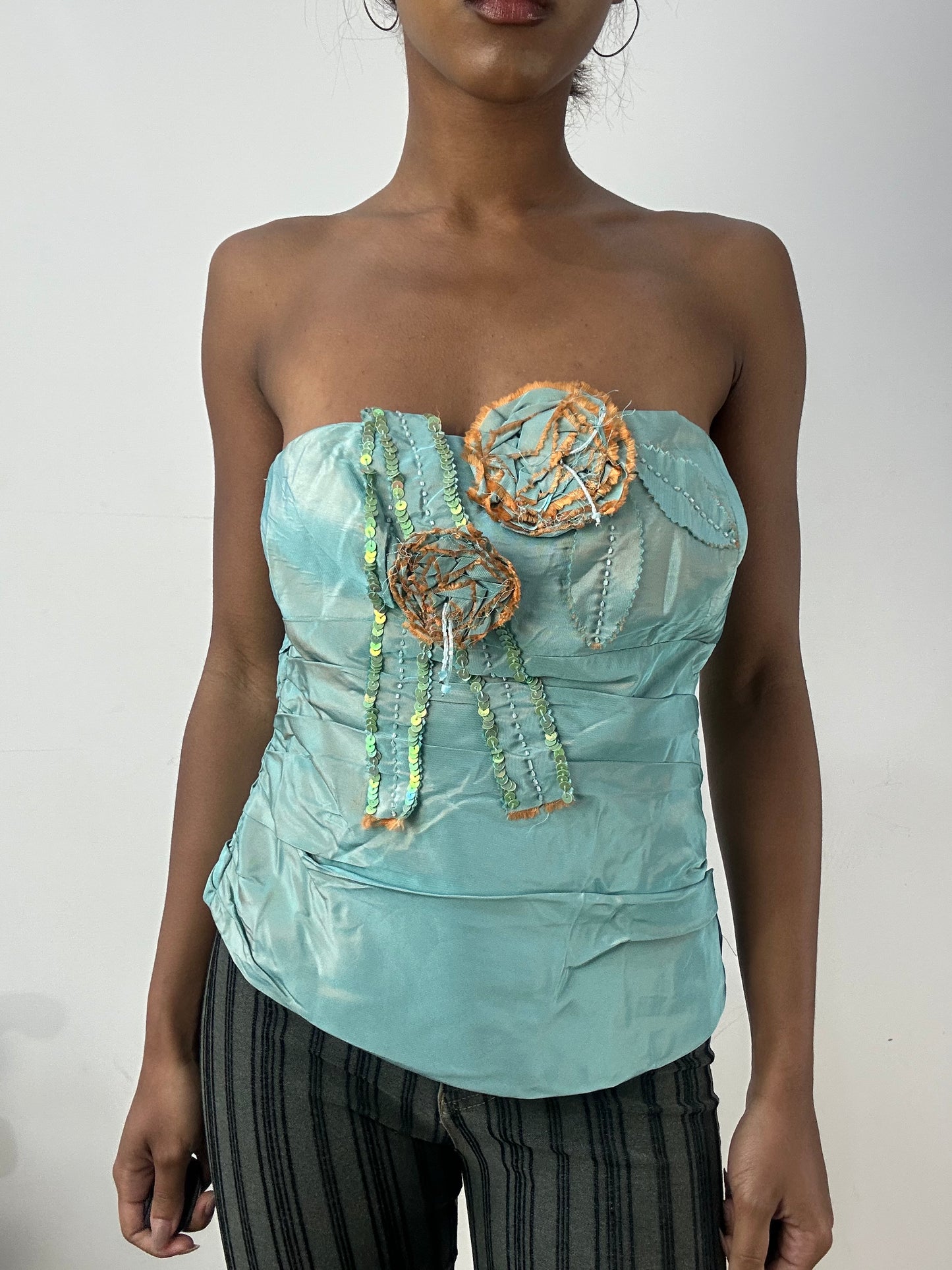 BEST PICKS | small blue iridescent corset top with 3d flower detail