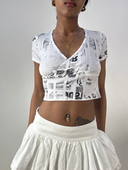 💻‼️ white and silver crop top with graphic newspaper print