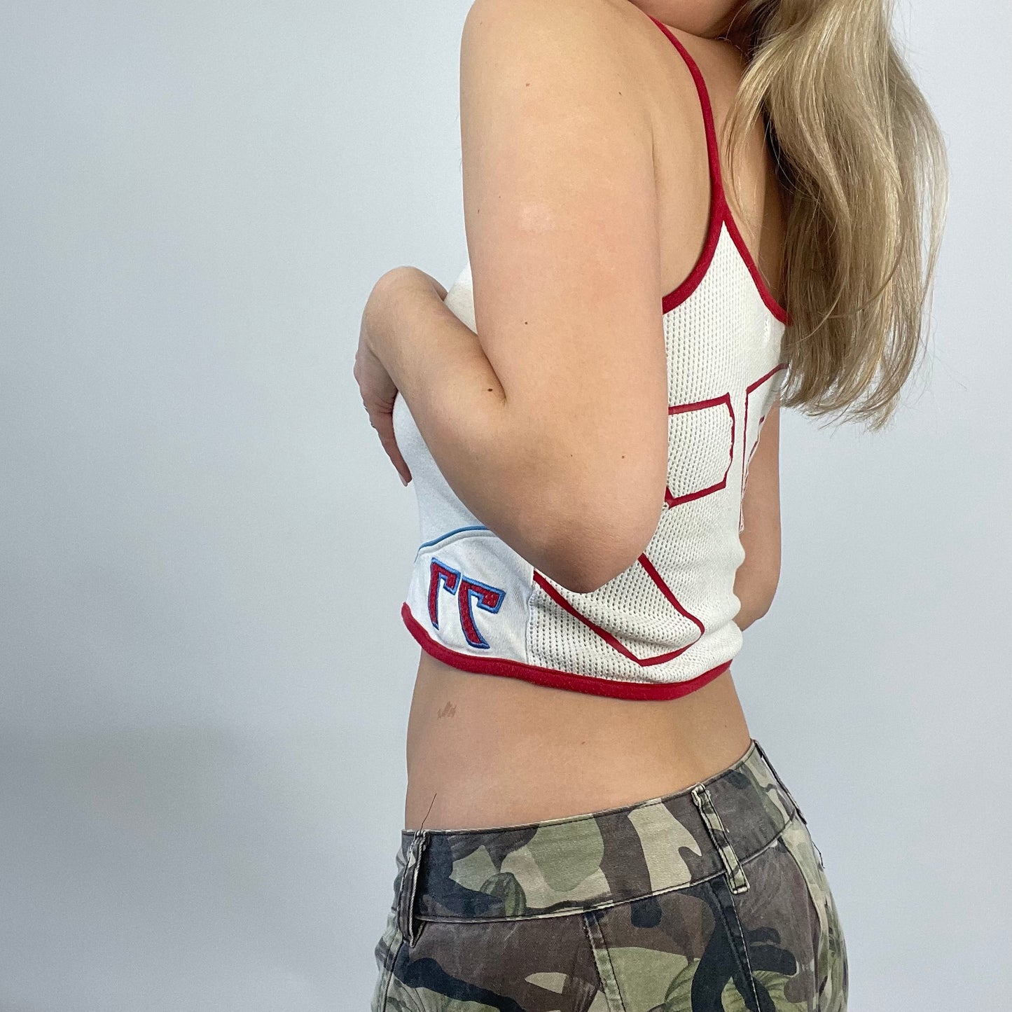 ELEVATED SPORTSWEAR DROP | small white sporty cropped vest with graphic fishnet back