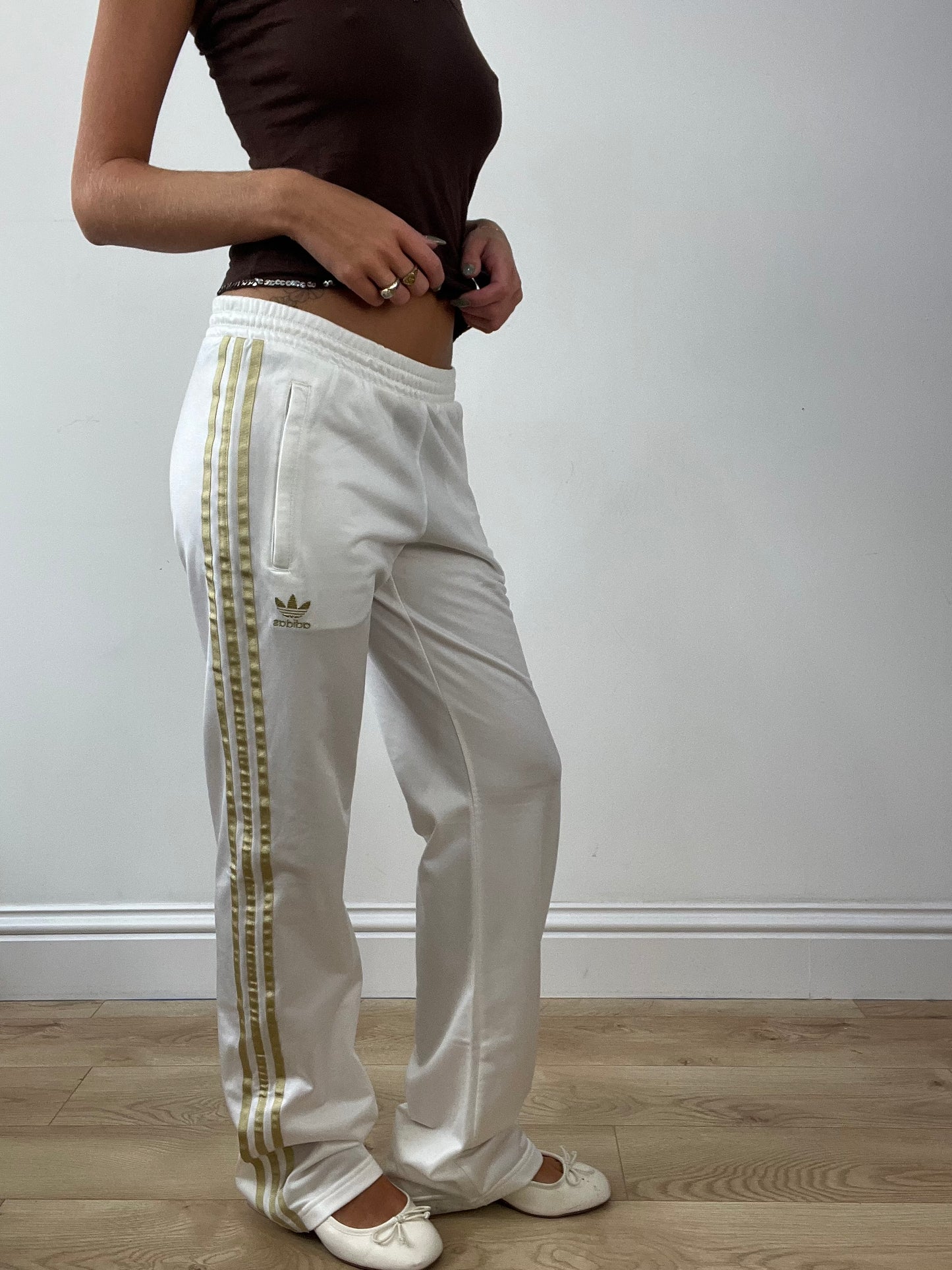 GIRLBAND DROP | medium white adidas tracksuit bottoms with gold stripes