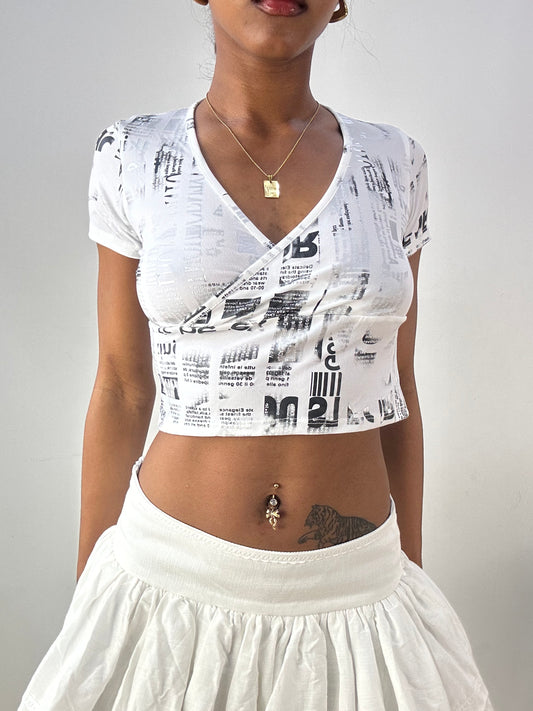 💻‼️ white and silver crop top with graphic newspaper print