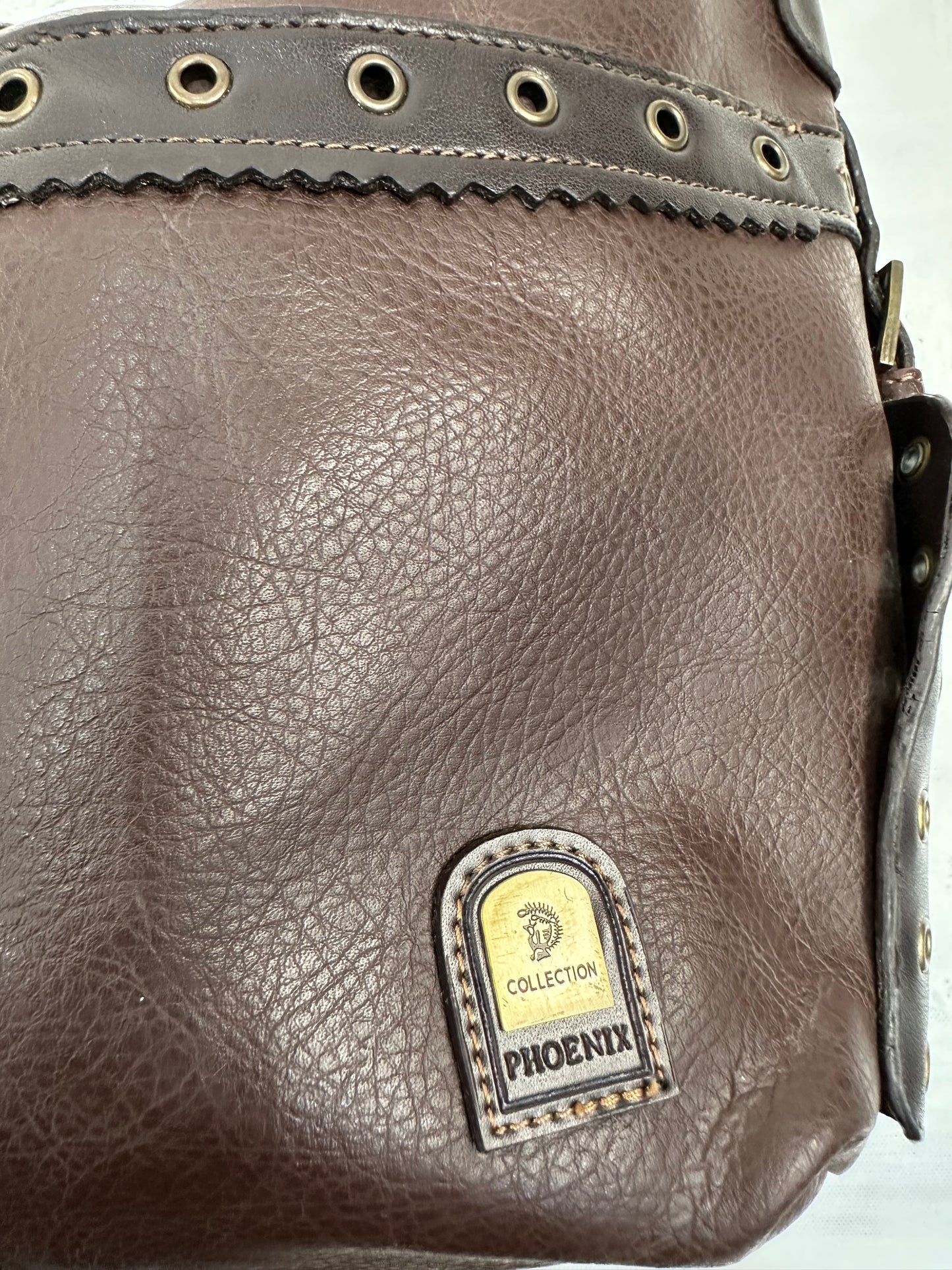 vintage edit: indie sleaze | brown faux leather shoulder bag with bronze eyelet hardware