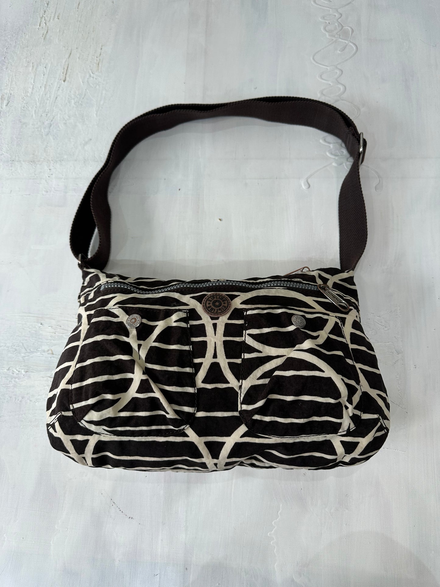 vintage edit: halloween | brown and white kipling shoulder bag with silver hardware
