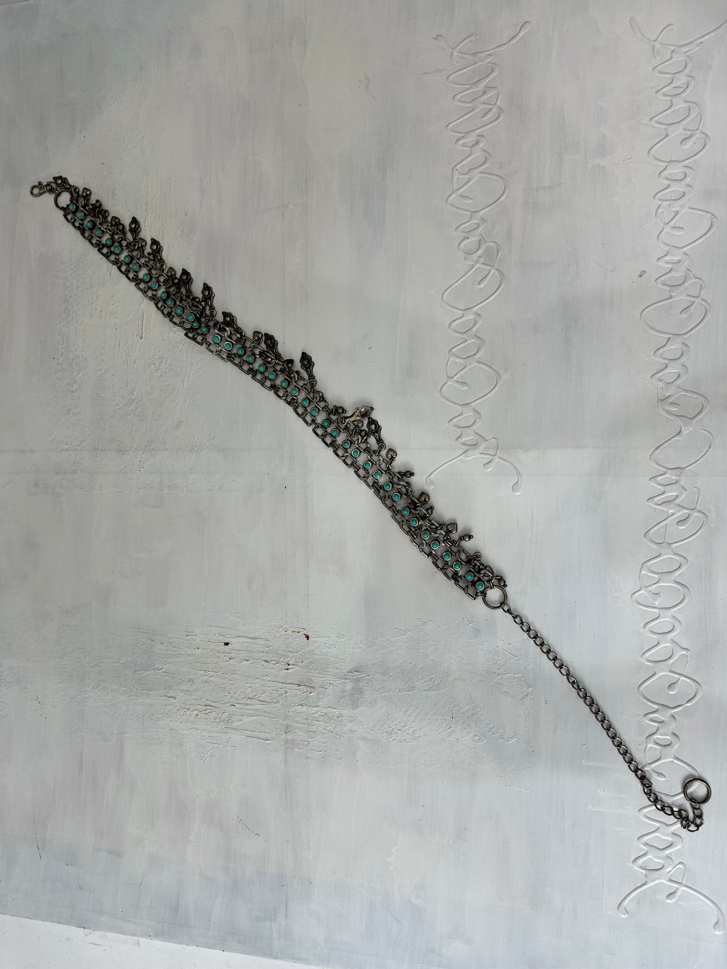 BEST PICKS | silver and blue chain belt with drop metal hardware details