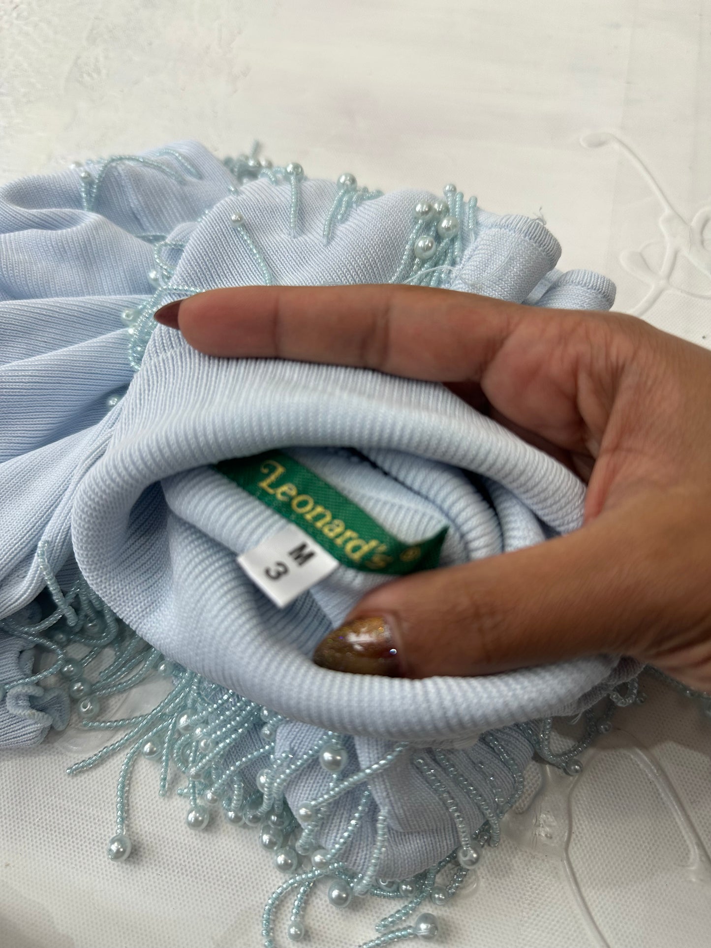 LFW edit | small baby blue sleeveless turtleneck top with beading detail