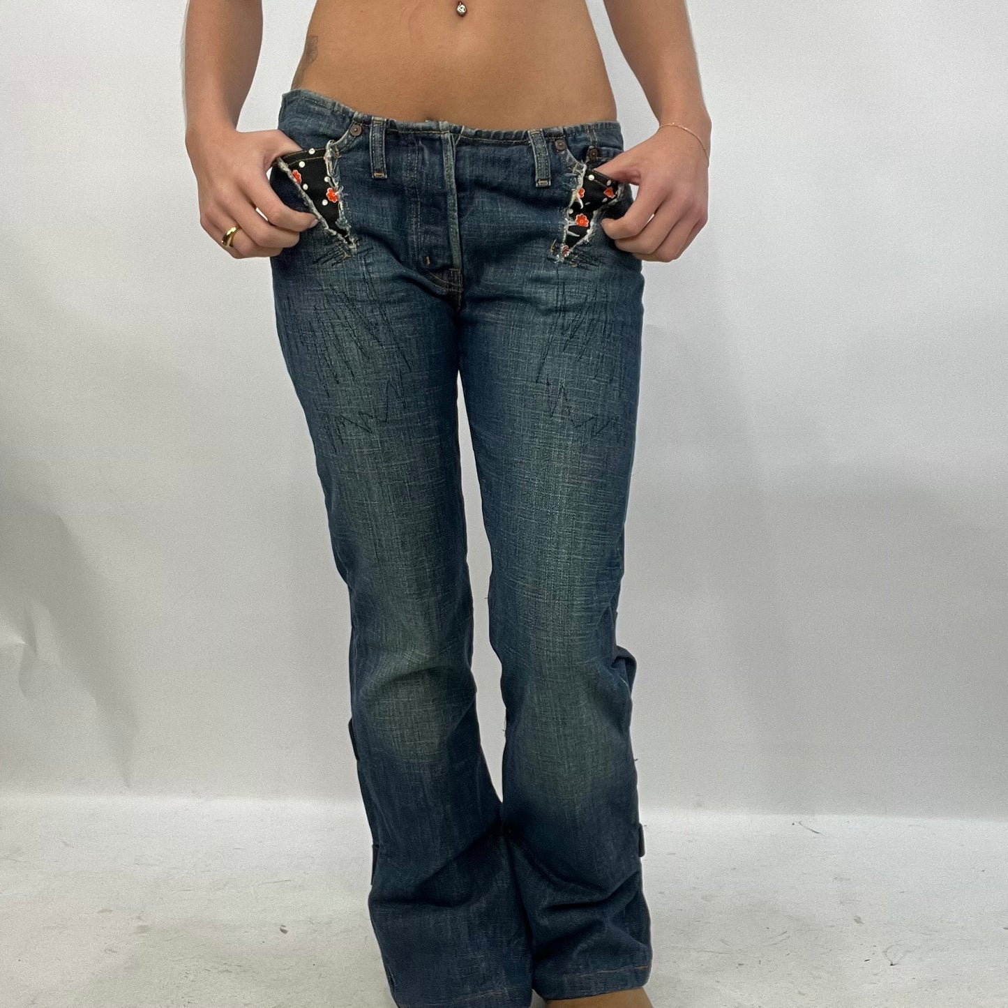 HIPPY CHIC DROP | small dark wash low waisted denim flared jeans with orange flower detail on pockets