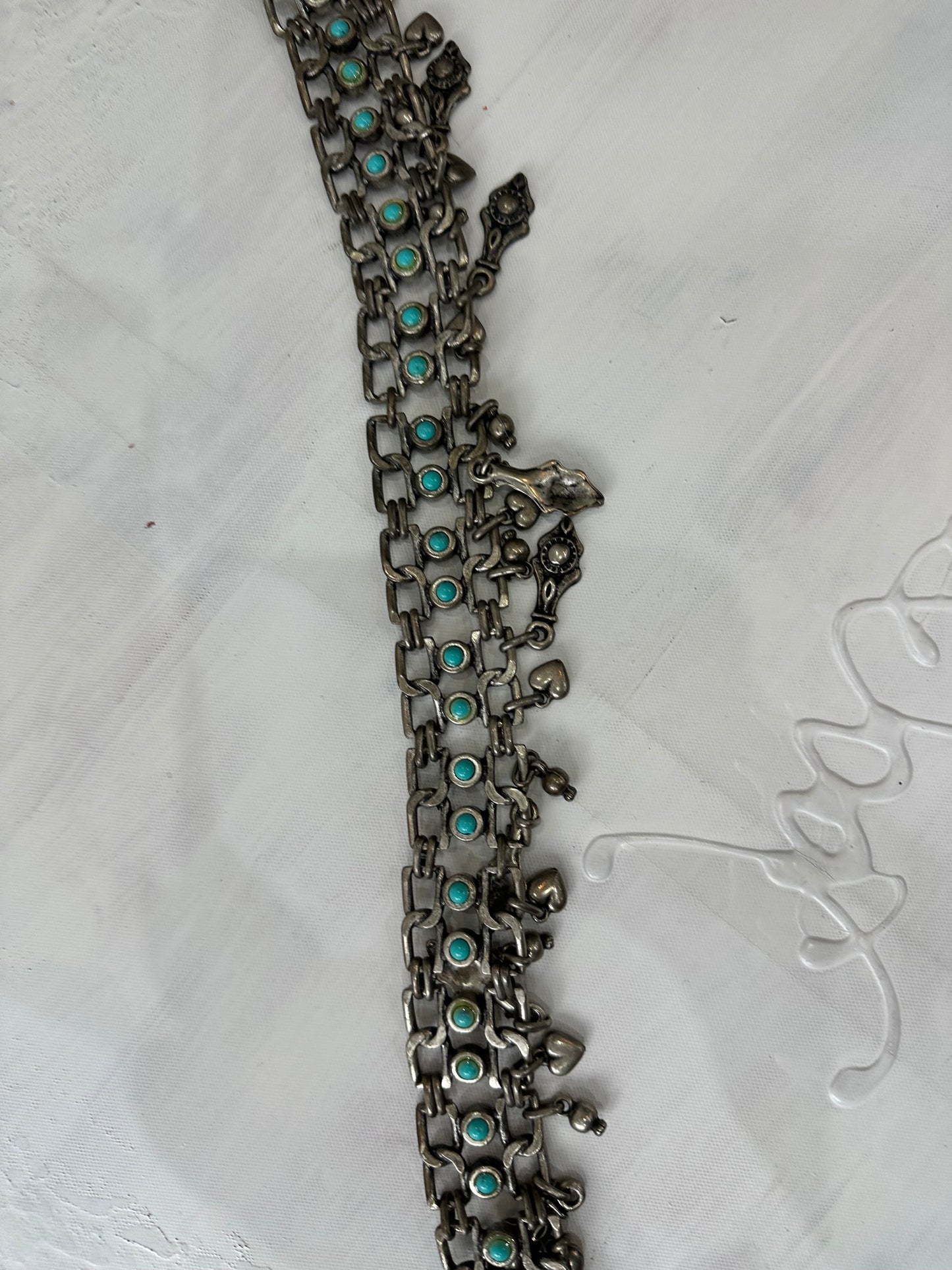 BEST PICKS | silver and blue chain belt with drop metal hardware details
