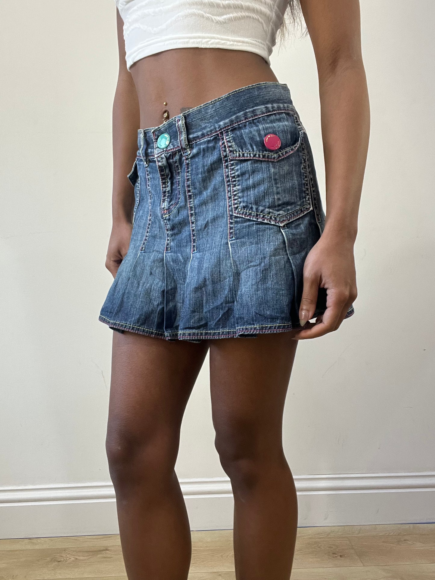 2016 edit | medium denim pleated mini skirt with pink spellout on the back