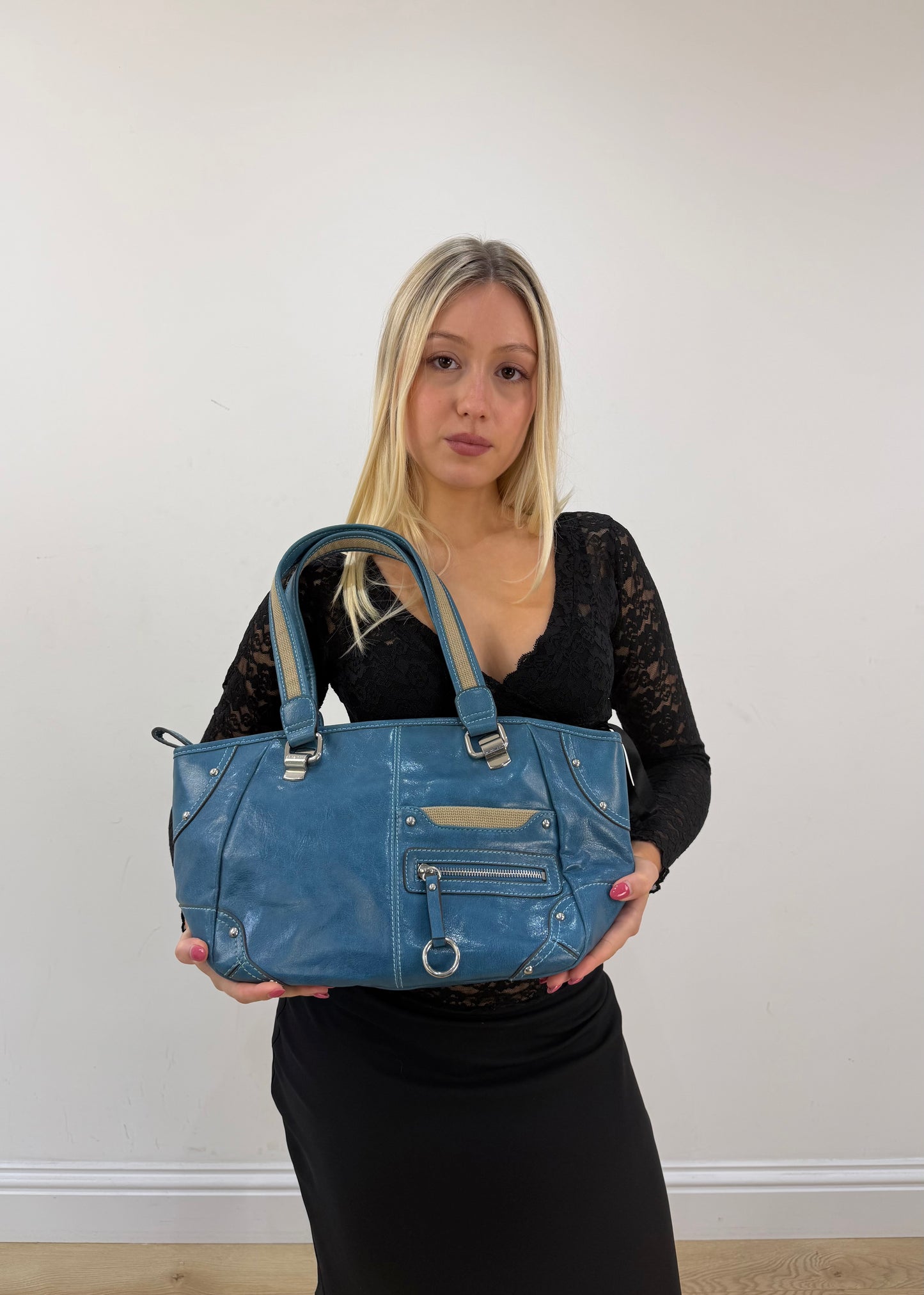 blue shoulder tote bag with silver hardware detail view