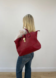 red structured shoulder bag with gold ring hardware detail view