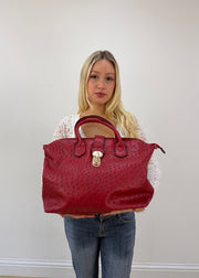 red structured shoulder bag with gold ring hardware detail view